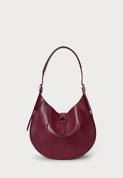 Burgundy leather handbag with a curved shape, a short strap, and a front pocket detail. Smooth texture with minimal hardware accents.