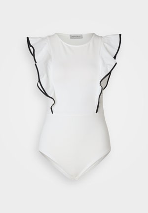 Valge bodi, millel on musta äärisega volangvarrukad. Sile kangas, ümmargune kaelus ja lähedalt kehale liibuv disain. Minimalistlik stiil.