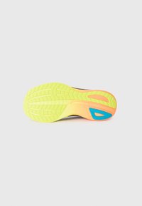 Shoe sole featuring a bright yellow base with textured tread, orange accents, and a blue detail on the side; lightweight design.