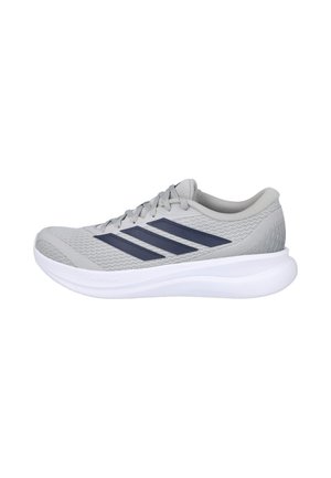 Zapatilla de correr gris clara con rayas azul oscuro, suela blanca gruesa y cordones, mostrada de lado sobre fondo blanco.