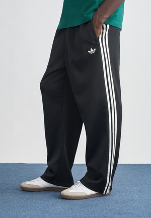 LOOSE - Tracksuit bottoms - black/white