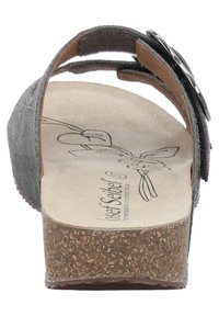 Gray suede sandal with a cork sole, adjustable strap, and a decorative black button accent. Interior features curved brown footbed outline.