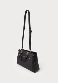 Black handbag with two top handles and an adjustable shoulder strap. Features a front zipper pocket and textured synthetic material.