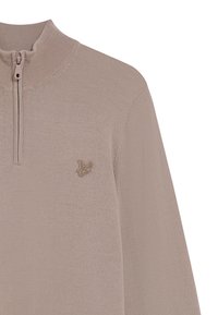 Helle beige Zip-Hoodie mit hohem Kragen, gerippter Struktur und gesticktem Logo-Detail auf der Brust. Glattes, weiches Material.