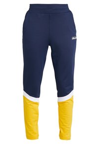 Mörkblå träningsbyxor med en gul nederdel, vita accentband och resårmidja. Gjorda av smidigt, stretchigt material.