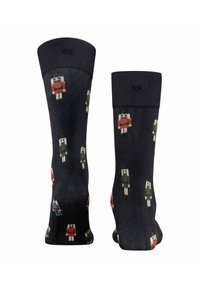 Czarne skarpetki z kolorowymi wzorami dziadka do orzechów. Wykonane z miękkiego materiału o gładkiej fakturze, z różnymi wzorami dziadka do orzechów.