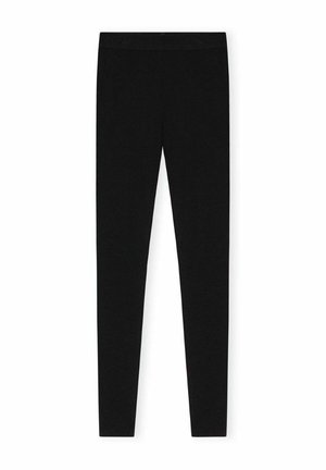 Mustad mustadest kangast retuusid, millel on veniv materjal, kõrge talje ja libisev, keha lähedane disain. Ilma nähtavate mustrite või aktsentideta.