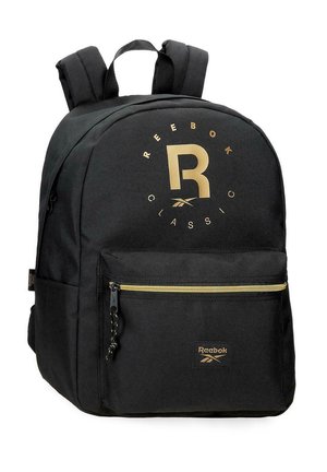 Mochila Reebok Classic negra con logo dorado, bolsillo frontal con cremallera, correas acolchadas para los hombros y asa superior de transporte.