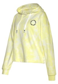 Sudadera amarilla con diseño tie-dye, de corte corto y holgado. Presenta un logo frontal y capucha ajustable con cordones. Fabricada en suave tela de algodón, con mangas largas.