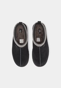 Black suede slippers with a plush interior, featuring a decorative patterned trim around the opening and subtle stitching details.