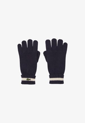 Guantes de punto color navy con cinco aberturas para los dedos, puños acanalados con una franja blanca y un pequeño logo de cocodrilo verde en la muñeca.