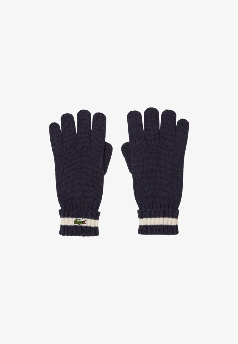 Guantes de punto color navy con cinco aberturas para los dedos, puños acanalados con una franja blanca y un pequeño logo de cocodrilo verde en la muñeca.