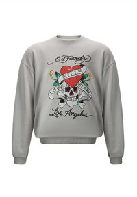 Grå sweatshirt med ett grafiskt motiv med ett skelett, hjärta och texten "KILLS LOVE SHOW." Ribbad mudd och nederkant ger textur.