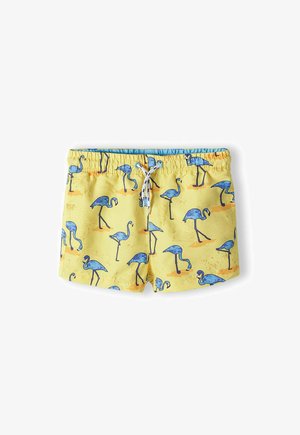 Žlté plavky s potlačou modrého plameniaka, elastický pás s šnúrkou a hladký povrch.