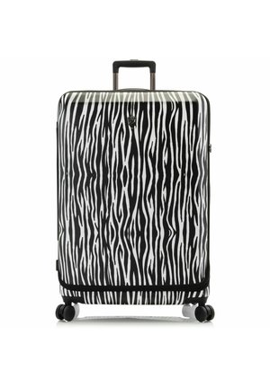 Hard-shell suitcase with a black and white zebra stripe pattern. Features four wheels, a retractable handle, and a zip closure.