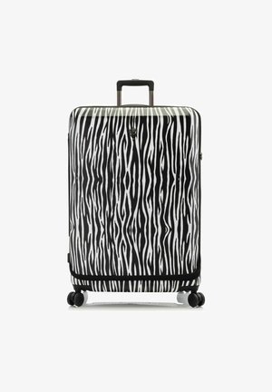 Valigia rigida con motivo a strisce zebra in bianco e nero. Dotata di quattro ruote, manico retrattile e chiusura a zip.