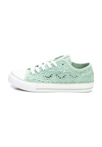 Zapatillas de encaje verde claro con una suela de goma blanca y una puntera blanca. Presentan cordones blancos y un patrón de encaje texturizado en la parte superior.