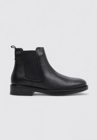 Black leather chelsea boot with elastic side panels, round toe, and a low stacked heel. Smooth texture with minimal stitching details.