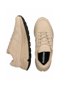 Béžové semišové sneakers s texturovaným designem, šněrováním a silnou černou gumovou podrážkou. Název značky "BLACKSTONE" viditelný uvnitř.