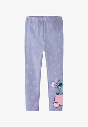 Paarse leggings met roze belpatronen en een klein cartoonachtig blauw buitenaards wezentje dat op een roze bal zit bij het onderste rechterbeen.