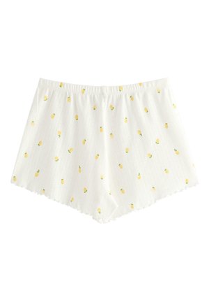 Short blanc côtelé avec petites impressions de citrons jaunes et ourlet festonné, doté d'une taille élastique.