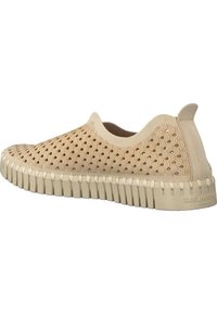 Scarpe slip-on beige con tomaia in tessuto a fantasia, suola in gomma testurizzata e design curvo. Presentano una linguetta sul tallone per una facile indossabilità.