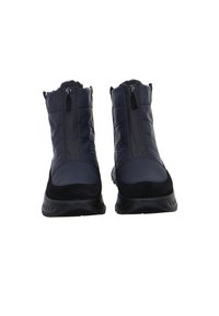 Black insulated winter boots with front zippers and sturdy soles, shown upright and facing forward on a white background.