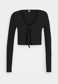 Svart ribbad kort topp med v-ringning, långa ärmar och snöre i framsidan. Texturerat tyg med en kroppsnära design.