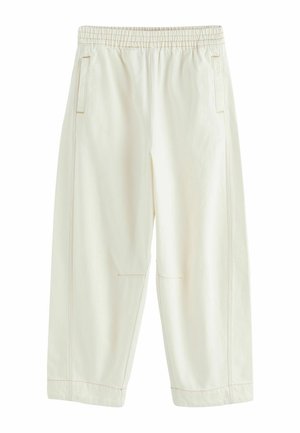 Cream-colored loose-fit pants with elastic waistband, side pockets, and visible stitching along the seams and hems.
