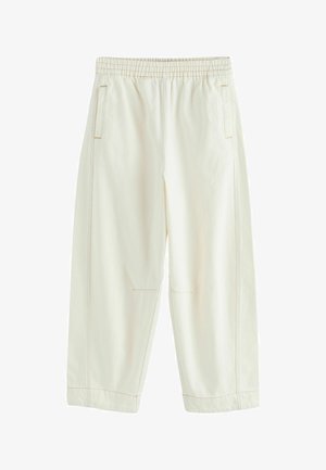 Kreemika värvi lahtised püksid, millel on elastne vöökoht, küljetaskud ja nähtav õmblusõmblused mööda õmblusi ja sääri.