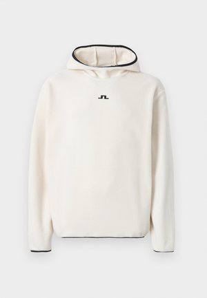 Cream-colored fleece hoodie with a high neck, black trim on the hood and sleeves, featuring a small black logo on the chest.