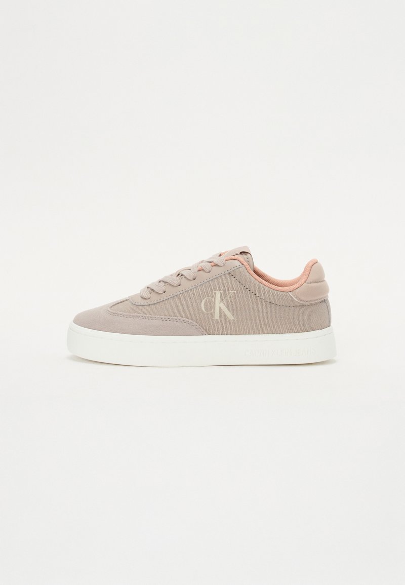 Light taupe sneaker with a textured fabric body, pink accents on the collar, and a white rubber sole. Features logo detail on the side.