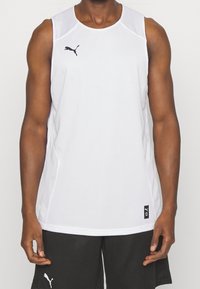 Maglietta atletica bianca senza maniche con un design in rete testurizzata e logo Puma nero sul petto; presenta un collo rotondo e cuciture laterali.