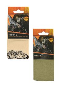 Socken in beiger und grüner Verpackung. Die beigefarbenen Socken haben ein Dinosaurier-Motiv, während die grünen Socken einfarbig sind. Beide sind mit Größenangaben versehen.
