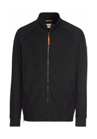 Zwarte dichtritsjas met hoge kraag, gestructureerde stof, contrasterende oranje ritssluiting, en zijzakken. Voorzien van raglanmouwen.