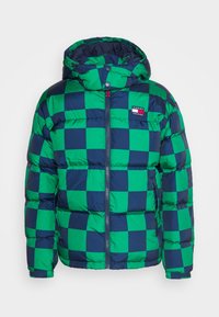 Green and navy checkered puffer jacket with a hood, featuring a front zip and logo patch on the left chest. Soft, quilted texture.
