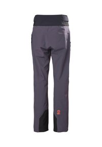 Pantalon d'extérieur gris foncé et noir avec poches latérales zippées et logo orange sur la partie inférieure arrière de la jambe, vu de dos.