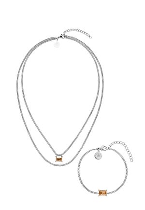 Silver double-layer necklace and matching bracelet each featuring a rectangular amber-colored gemstone and adjustable chain clasp.