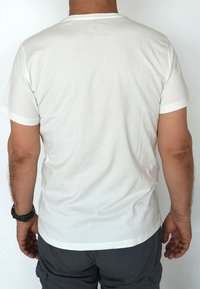 White cotton t-shirt with a crew neck and short sleeves, plain texture, no patterns, viewed from the back with arms relaxed at sides.