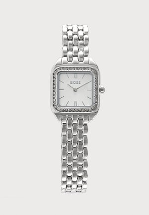 Silberne quadratische Armbanduhr mit kristallbesetzter Lünette, weißem Zifferblatt, römischen Ziffern und verbundenem Metallband.