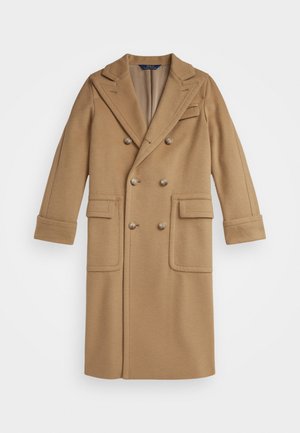 Double-breasted coat in camel wool, featuring a notched collar, two front pockets, and decorative buttons. Smooth texture with tailored design.