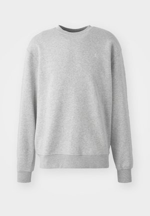 Szürke pulóver, puha anyagból készült, sakkkereszt nyakú, bordás mandzsettákkal és szegéllyel, az elején diszkrét logóval.