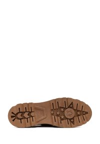 Brown rubber sole featuring deep treads and a star pattern with five smaller stars. Textured surface and durable design for traction.