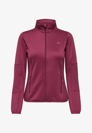 Veste zippée pour femme de couleur rose foncé avec col montant, deux poches latérales zippées et texture côtelée sur les manches et les côtés.