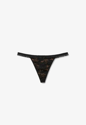 String noir en dentelle avec motifs floraux, une taille élastique avec des détails froncés, et un design sans couture pour le confort.