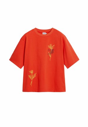 Red cotton t-shirt with short sleeves, featuring yellow embroidered floral designs on the front and text that reads "I LOVE WHO I AM."