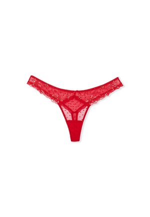 Tanga in pizzo rosso con pannelli trasparenti, texture a pois, decorazioni floreali e bordi ondulati, caratterizzato da un design minimal e da spalline sottili.