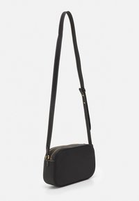 Svart läder crossbody-väska med rektangulär form, guldfärgad dragkedja och justerbart bälte. Slät textur med kontrasterande sömdetaljer.