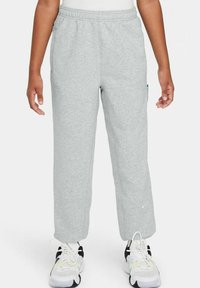 Pantalones de chándal grises de algodón con cintura elástica, dos bolsillos laterales y un pequeño logo en la pierna. Diseño de pierna recta.