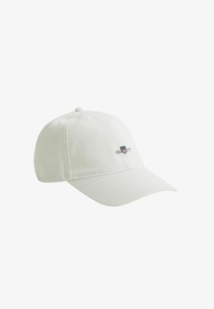 Weißes Baseballcap mit gebogenem Schirm und kleinem, auf der Vorderseite gesticktem Logo, das stilisierte Buchstaben und Sterne zeigt.